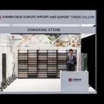 Dongxing Group (DONGXING STONE) exhibition booth at MosBuild 2026 in Moscow, featuring terrazzo artificial stone and natural stone samples, company logo, and professional reception area for building materials industry visitors