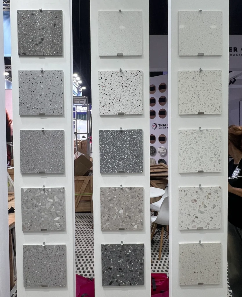 Wide range of precast terrazzo color and aggregate samples at Dongxin booth, showing light, dark, and neutral tones for custom terrazzo projects