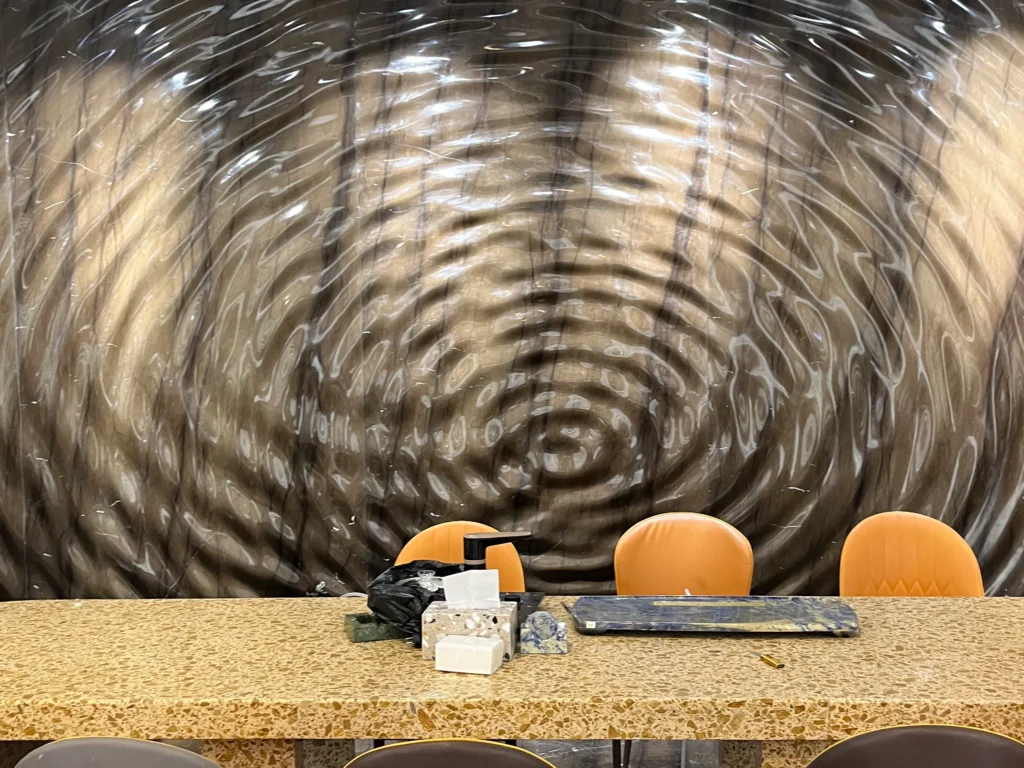 3D ripple curved marble feature wall, golden aggregate terrazzo dining table for hotel restaurant interior project