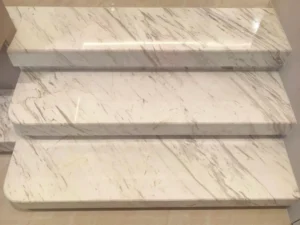 Clean white marble staircase after we remove yellow stains on marble, showing a bright, restored surface free of discoloration