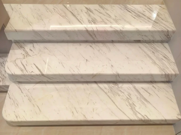 Clean white marble staircase after we remove yellow stains on marble, showing a bright, restored surface free of discoloration